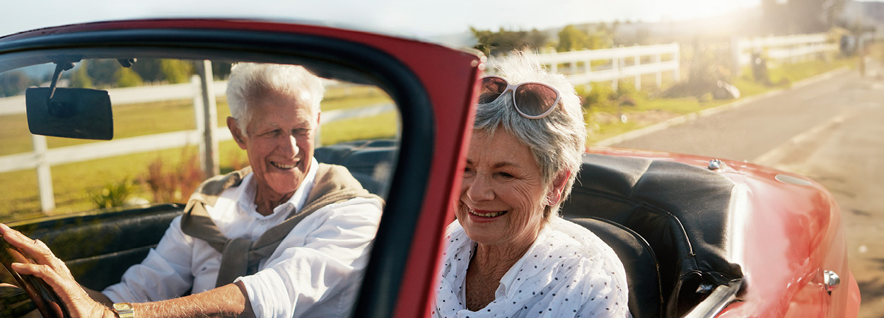 Seniors driving convertible